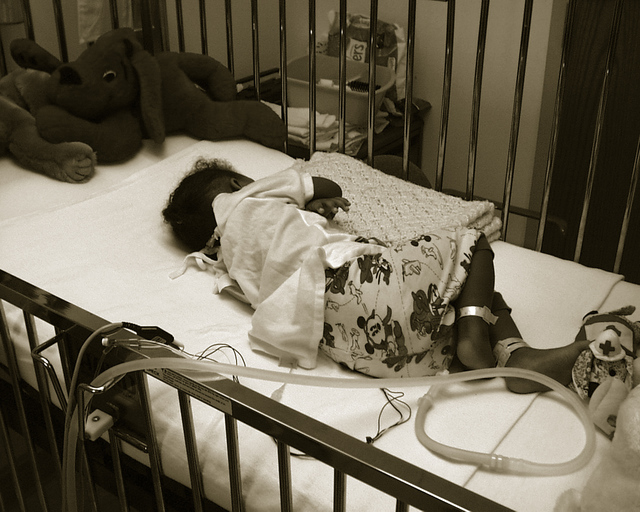 Sick Baby in cot in hospital Sick baby in cot with tubes
